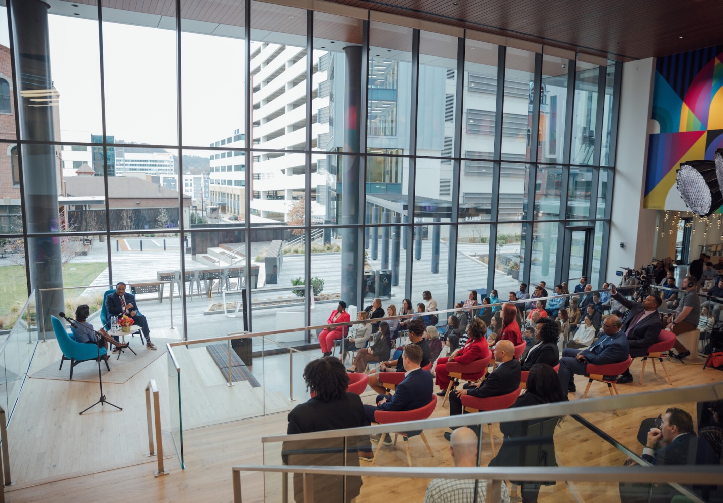 A seated crowd watching two people speak on stage at a Black History Month event at the Cencora headquarters.